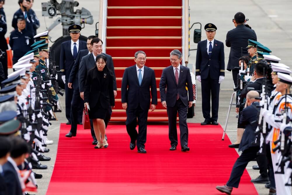 Foto do primeiro-ministro da China, com o presidente sul-coreano e primeiro-ministro japonês