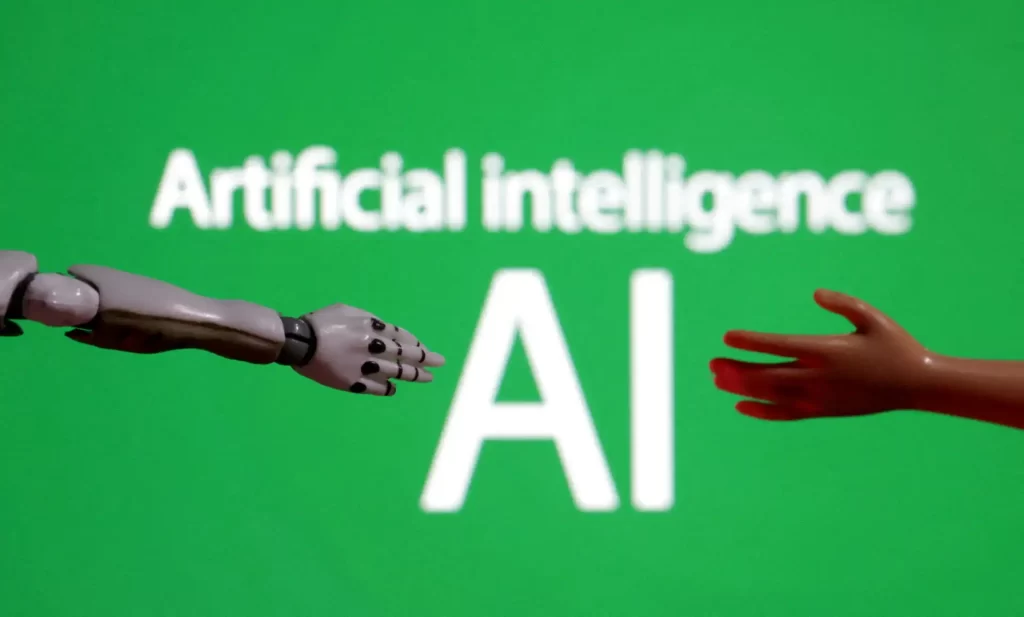 Imagem representativa de inteligência artificial, mostrando um braço robótico se estendendo em direção a uma mão humana sob o texto 'Artificial intelligence' e 'AI'.