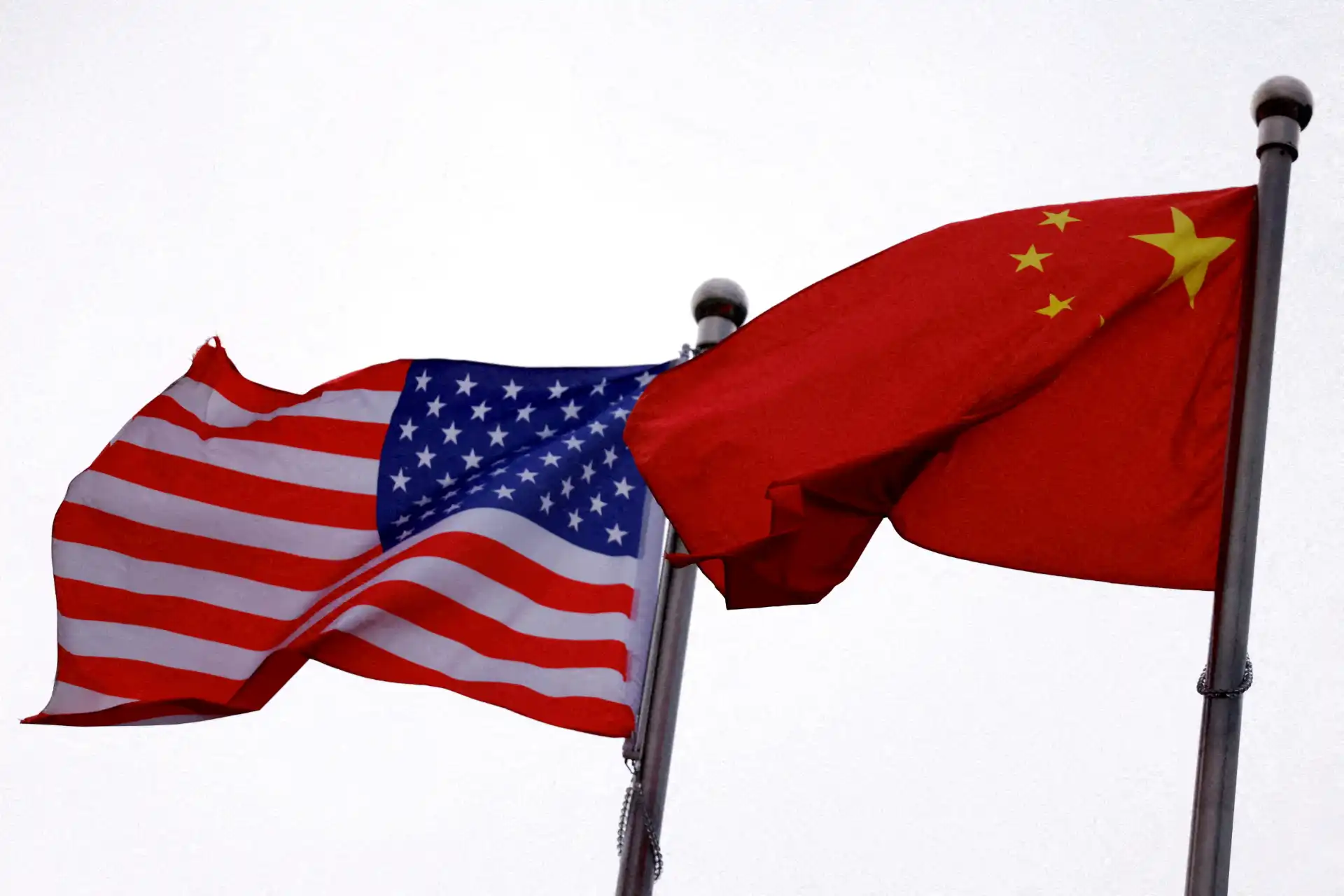 Imagem das bandeiras dos Estados Unidos e da China, simbolizando relações internacionais e comércio entre as duas potências.
