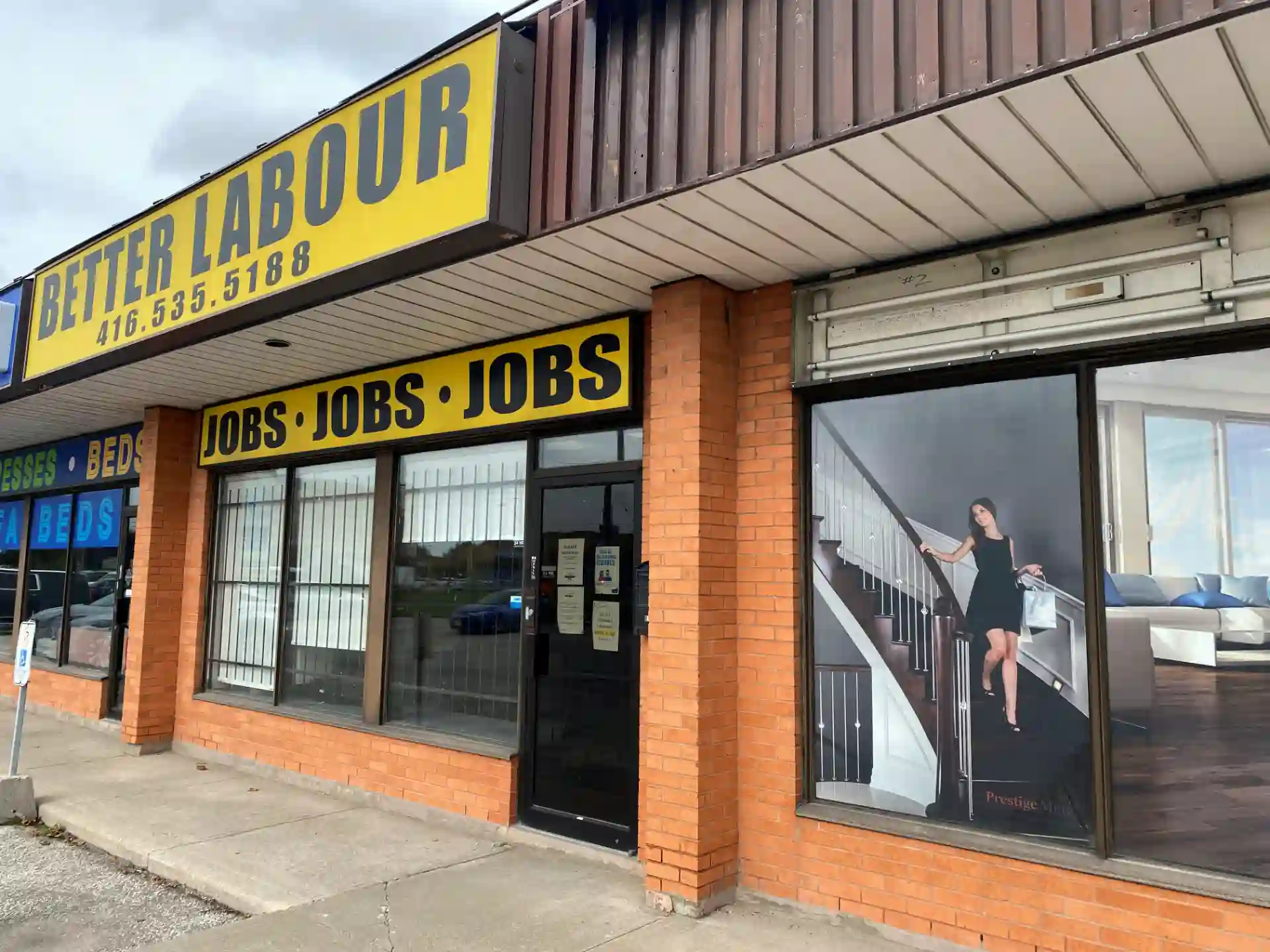 Fachada de uma loja de empregos chamada 'Better Labour' com anúncio de vagas de emprego, focada em oportunidades de emprego e mercado de trabalho.