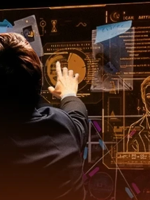 Duas pessoas analisando tecnologia de inteligência artificial com telas interativas exibindo gráficos e dados complexos, simbolizando inovação e ciência moderna.